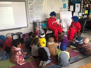 child reading to thing 1 and thing 2