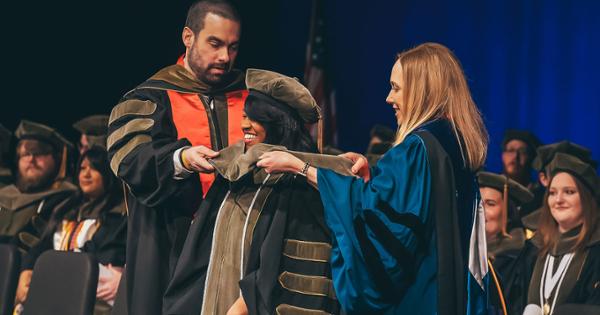 A Gatton College of Pharmacy student being hooded during ETSU's commencement ceremony