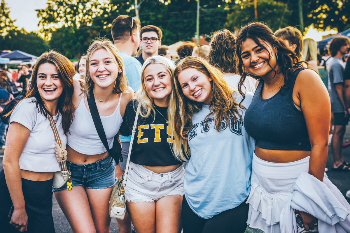 A photo of a group of students posing and smiling for the camera during Welcome Week.