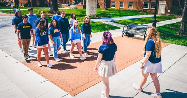 ETSU tour guides giving a campus tour to a group of prospective students