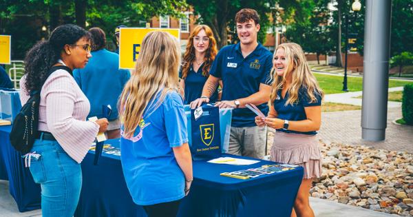 ETSU tour guides checking students in for Open House event