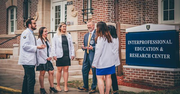 A group of ETSU students with their professor collaborating outside the Interprofessional Education and Research Center at ETSU