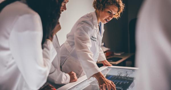 Quillen College of Medicine students studying the human body on an anatomage table