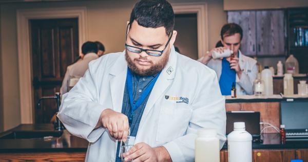 A Bill Gatton College of Pharmacy student compounding medication