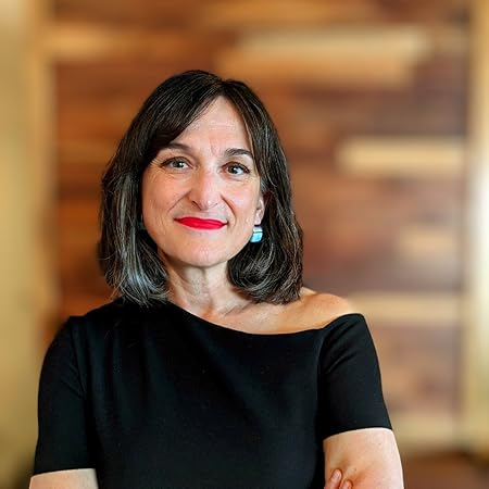 Photo of Dr. María Paz Moreno. She is wearing a black shirt and red lipstick. She is standing with her arms crossed in front of a wood block background.