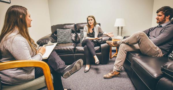 A small group of people on a couch in a discussion, representing counseling