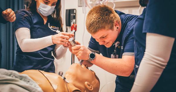 An ETSU student practices intubation on a mannequin