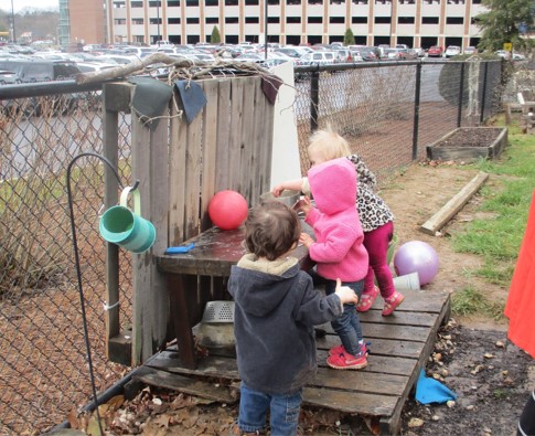 children playing in outdoor kitchen