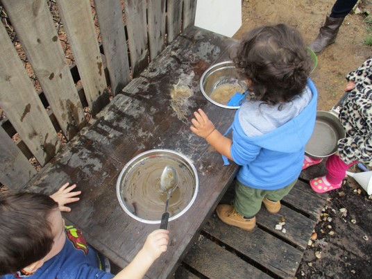 children "cooking" with sand and water