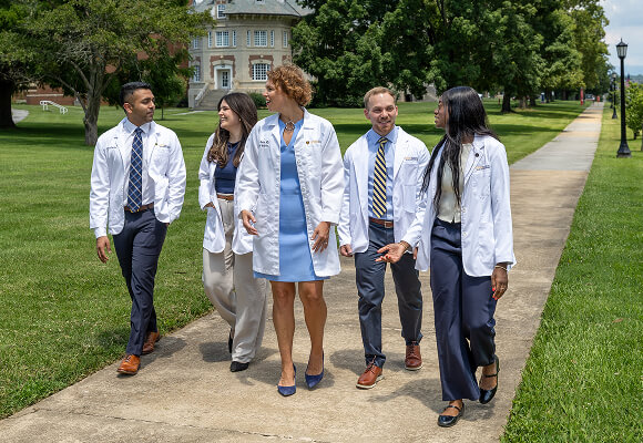 Dr. Reece walking the Quillen College of Medicine campus with students