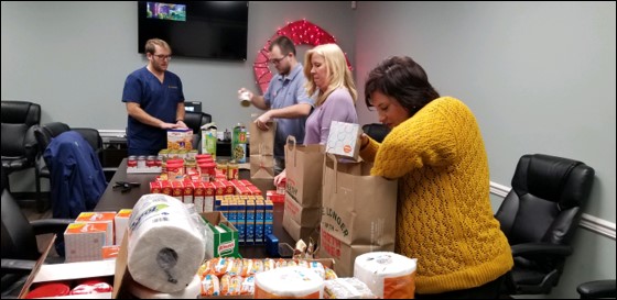 Team members filling up food pantry bags to give out to the community.