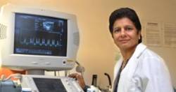 Dr. Krishna Singh using an ultrasound machine.