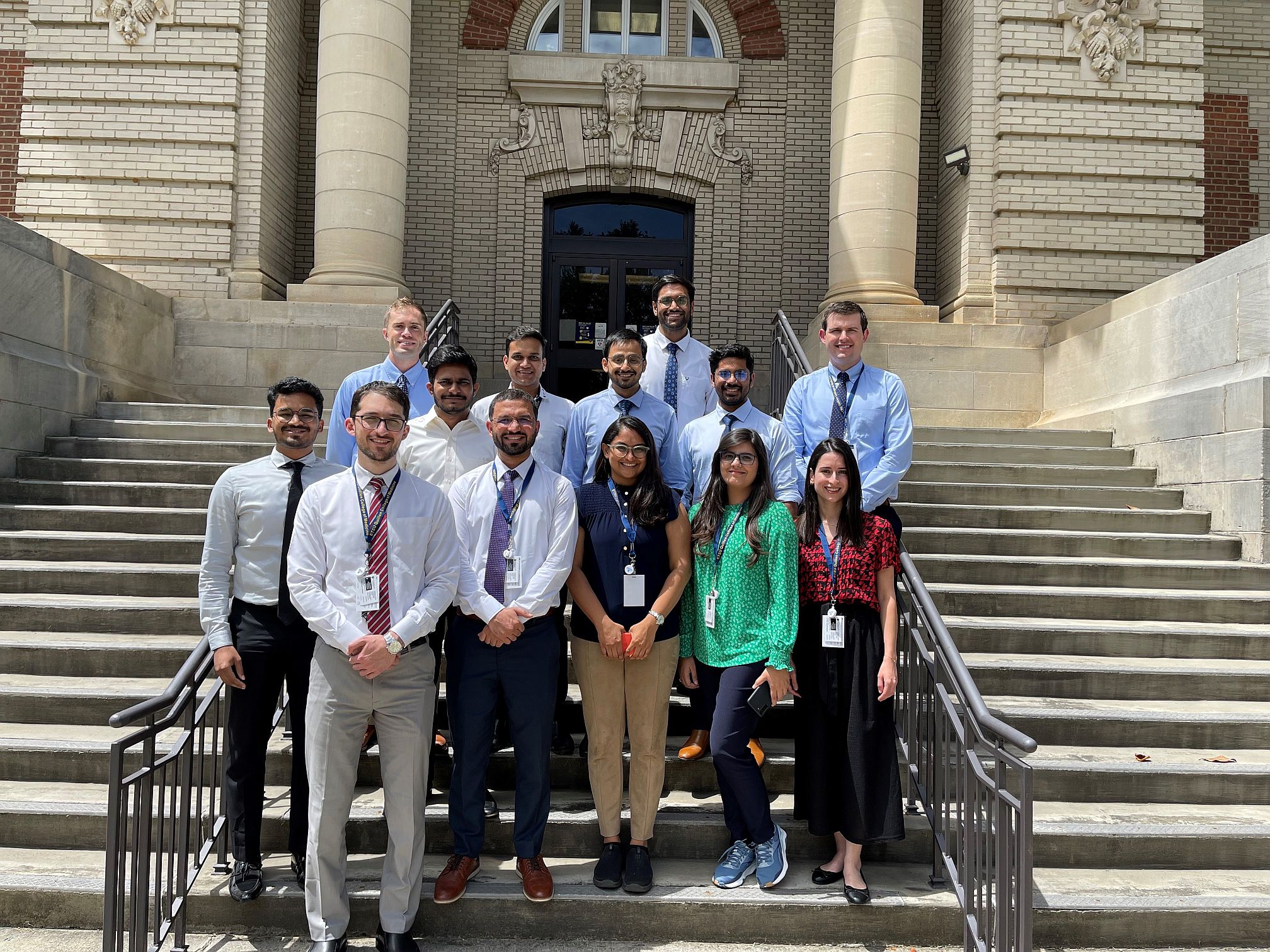 Group photo of third year residents standing on steps