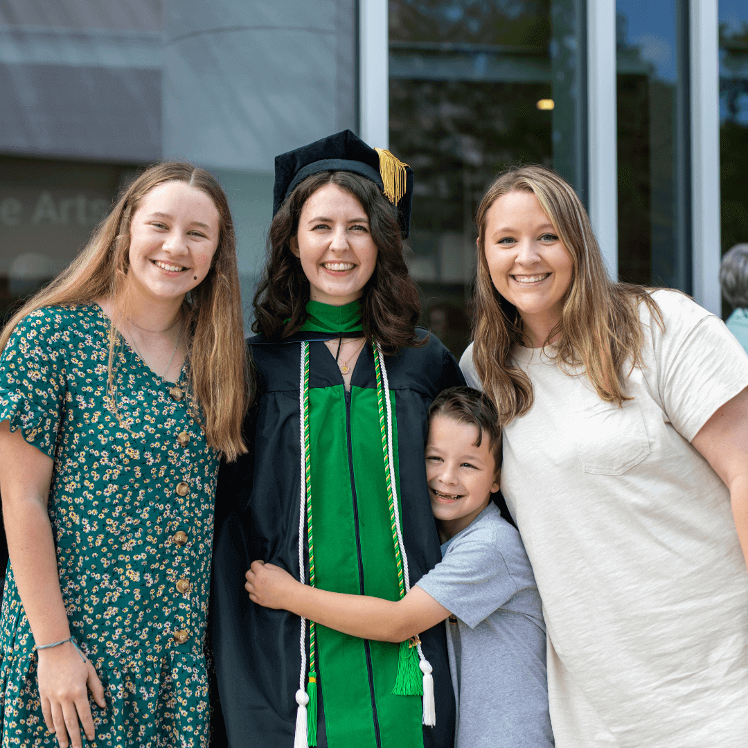 family and friends pictured hugging the 2024 medical school graduate.