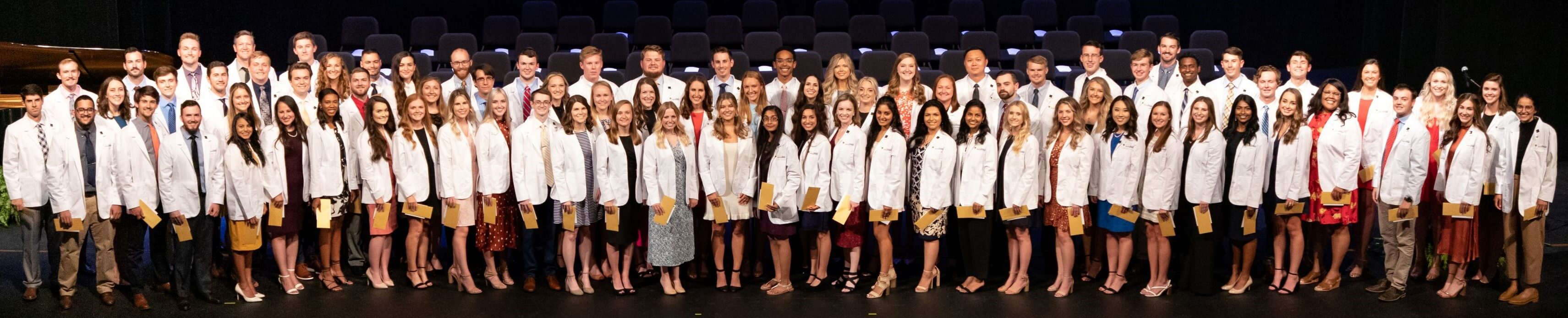 Group picture of the Class of 2025 after receiving white coats.