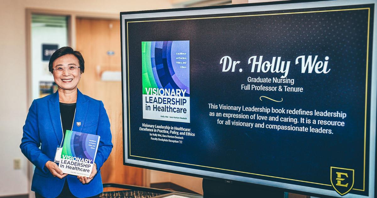 Dr Holly Wei with her book Visionary Leadership in healthcare: Excellence in Practice, Policy and Ethics