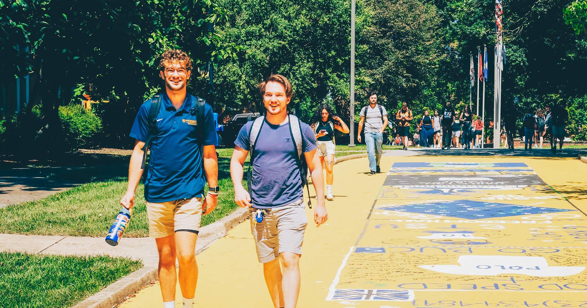 Students walk campus, near the former Pride Walk, in summer.