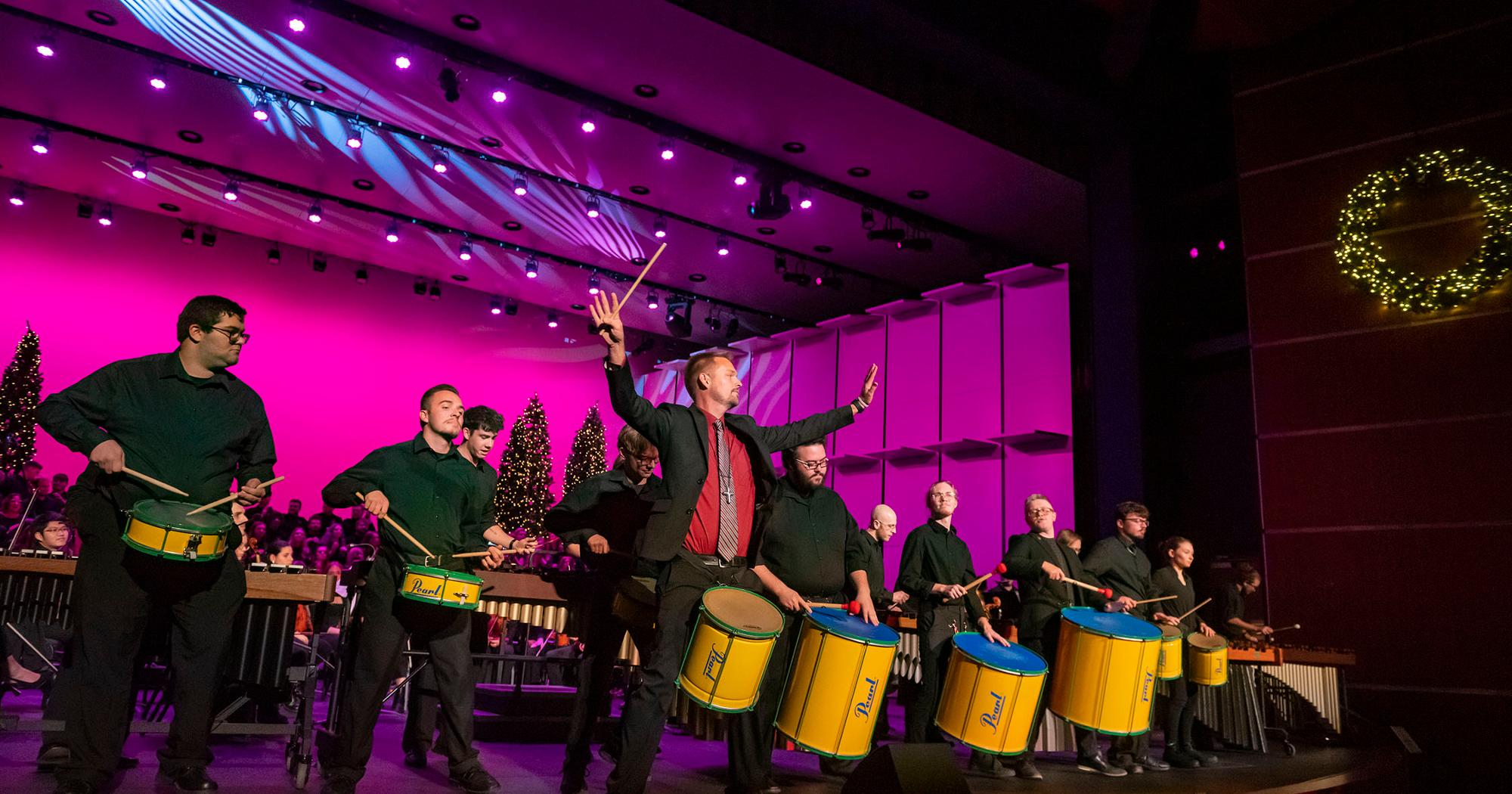 ETSU performers on hand at the 2023 holiday concert, with many playing drums. 