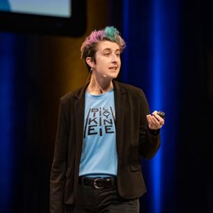 girl talking in black suit jacket with t-shirt