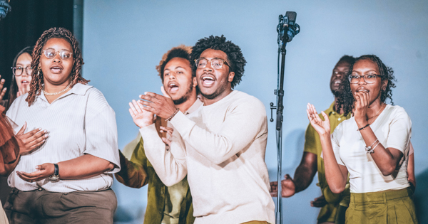 Members of the Gospel Choir clap to the music.