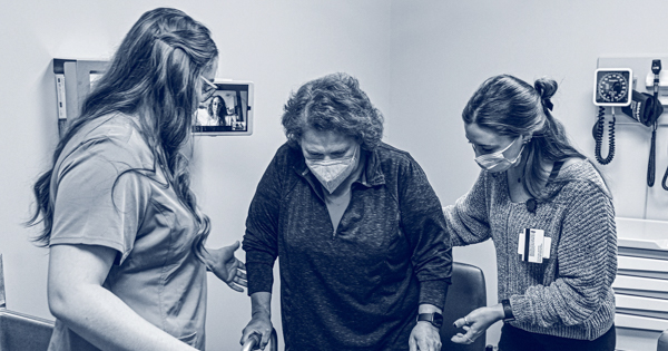 A photo of a standardized patient using a walker.