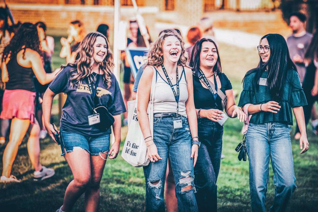 A photo of students talking and laughing.