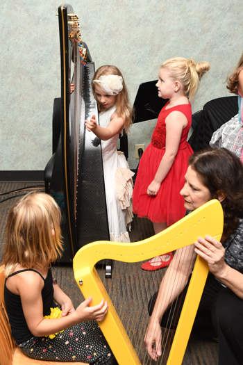 children experience the sound of harp music